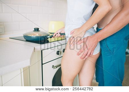 Cut View Of Guy Stands Aside O Girl And Holds His Hand On Her Buttocks. She Keeps Her Hand Further U
