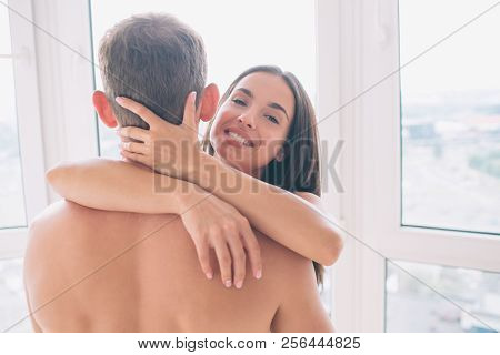 Cheerful Girl Looks On Camera And Smiles. She Poses With Guy. Girl Embrace Him On Neck. She Looks Ha