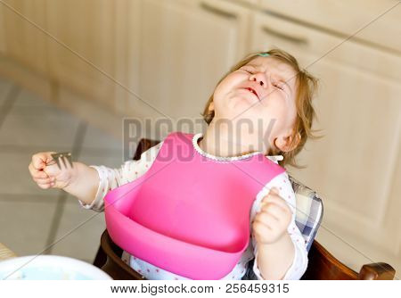 Sad Crying Baby Girl. Toddler Does Not Eating. Hysterical Child Learning Eat By Itself