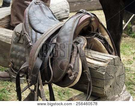 Leather Saddle Horse On A Barrier In The Stable