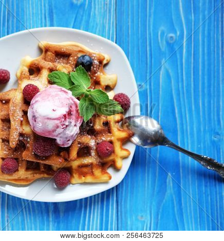 Belgian waffles with fresh berries and ice cream close up