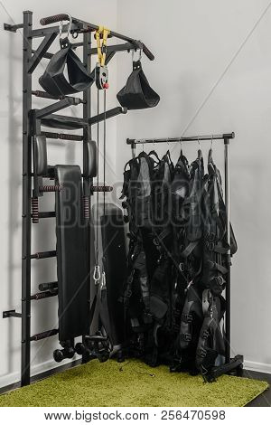 Electrical Muscle Stimulation Vests Hanging On Rack In Gym