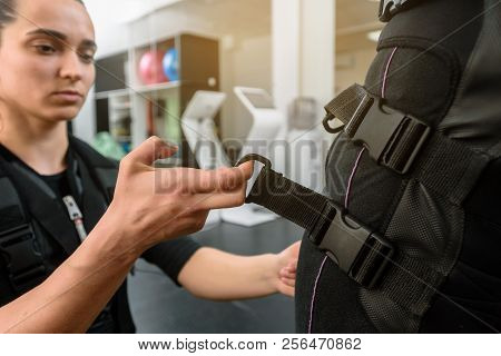 Closeup Of Young Woman Preparing Athlete For Ems Training