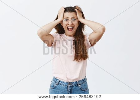 Studio Shot Of Panicking Desperate Woman In Despair Wearing Glasses And Casual Outfit Screaming Pull