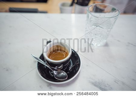 Coffee Mug And A Glass Of Water On A Table