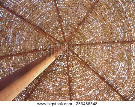 Straw Umbrella On The Sea. Under The Umbrella On The Beach On The Sea.