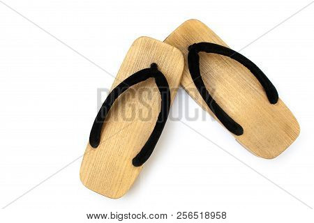 Close Up Old Used Wooden Japanese Sandal Isolated On White Background. It Is A Form Of Traditional J