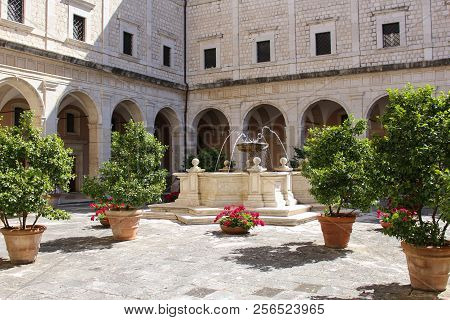 Courtyard With Fountain And Greenery In The Abbey Of Monte Cassino