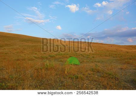 Landscape During Sunset In Geghama Mountains With A Green Tent In Armenia