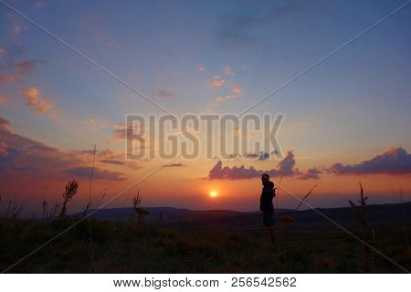 Young Man With A Landscape During Sunset In Geghama Mountains, Armenia