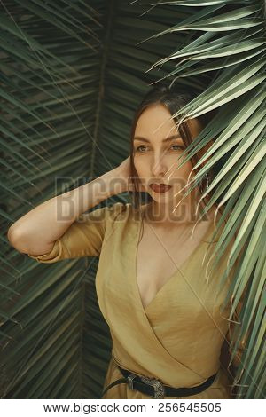 Stunning Woman Posing On Palm Leaves Background