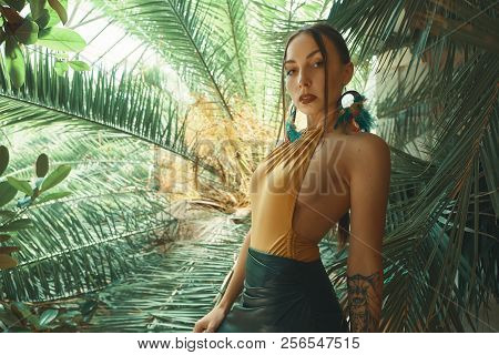 Attractive Young Woman Among The Tropical Plants.
