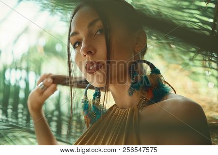 Attractive Young Woman Among The Tropical Plants.