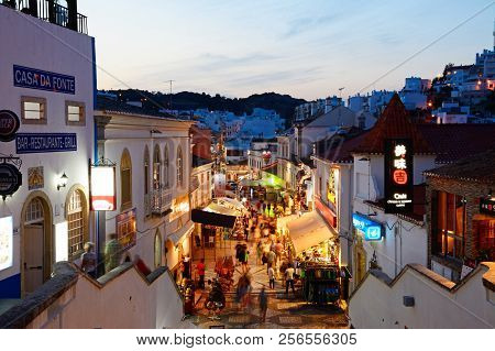 Albufeira, Portugal - June 12, 2017 - Elevated View Of The R 5 De Outubro Shopping Street In The Eve