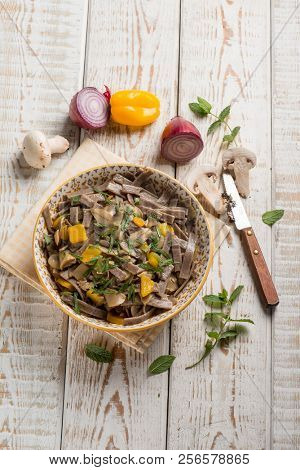 pizzocheri pasta with mushroom pepper and mint leaves
