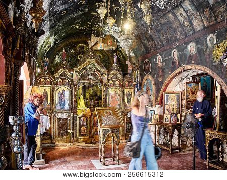 Athens, Greece - July 2, 2018. Parishioners And A Orthodox Priest At The Altar Of Ekklisia Agia Kiri
