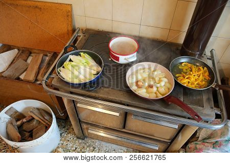 Many Pots On The Wood Burning Stove In The Kitchen