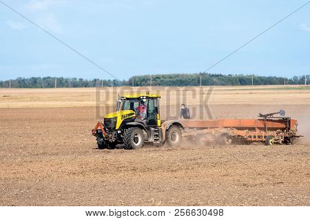 In The Autumn, The Farmer Processes The Fields With The Tractor And Sows The Seeds For The Next Harv