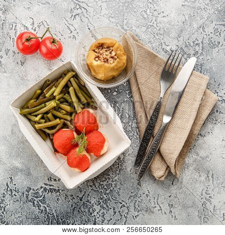 Boiled String Beans, Fish Balls In Sauce And Baked Apple In Lunchbox On A Gray Background. Healthy F