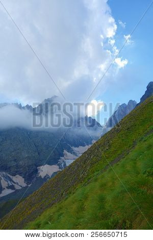 Descend From A Chaukhi Mountain Pass On A Hiking Trail Leading From Juta To Roshka In Caucasus Mount