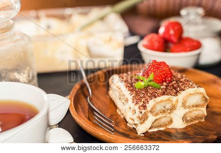 Tiramisu - Classical Dessert Garnished With Strawberry And Mint