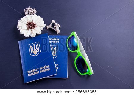 Two Ukrainian Overseas Passports On A Black Background With Glasses And A Flower