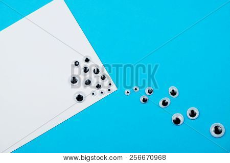 Abstract Pattern Many Plastic Toy Eyes On The Blue White Background Flat Lay Creative Surreal
