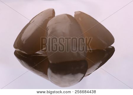 Dental Ceramic Veneers And Crowns Isolated With Mirror Background.