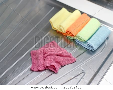Closeup Of Cottom Kitchen Towels On The Sinl Metal Surface