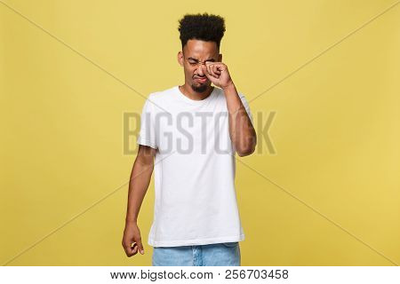 Closeup Portrait Man With Sad Expression, Isolated On Yellow Wall Background. Human Emotions, Body L