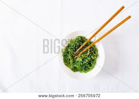 Wakame Chuka Or Seaweed Salad  With Sesame Seeds In Bowl On White Background. Traditional Japanese F
