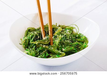 Wakame Chuka Or Seaweed Salad  With Sesame Seeds In Bowl On White Background. Traditional Japanese F