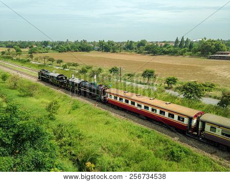 Nakhon Pathom, Thailand - Aug 12, 2015 : Old Thai Steam Locomotive Drives On The Railway Pass Throug