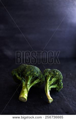 Fresh Brocoli On A Black Matte Background.