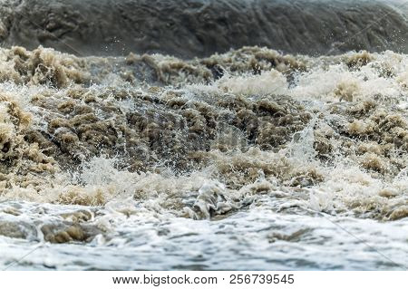 Flood Wave Water Disaster. Rushing Dirty Flood Water Closeup Photo. State Of Emergency.