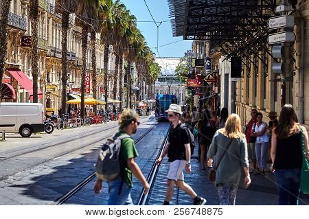 Montpellier, France - June 24, 2015: People Crossing The Road Through Tram Ways. View Of A City Stre