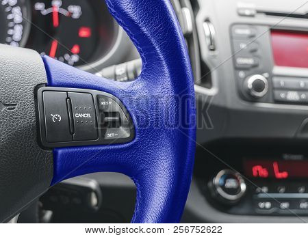 Cruise Control Buttons On The Blue Steering Wheel Of A Modern Car. Modern Car Interior Details. Car 