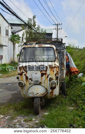 Can Tho, Vietnam - December 30th 2017. An Old Tuk-tuk Or Auto Rickshaw Lies Rusting By The Road Side