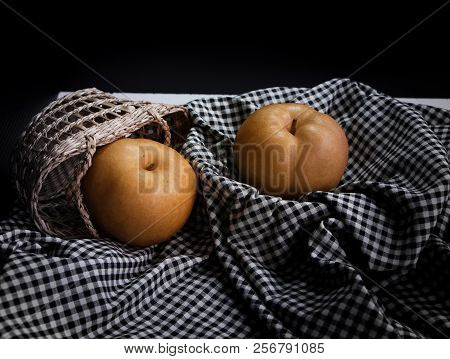 The Chinese Pear Put On Black And White Table Cloth,blurry Light Around