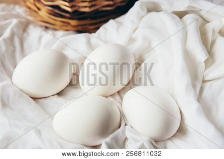White Chicken Eggs With Wodden Basket On A Tablecloth
