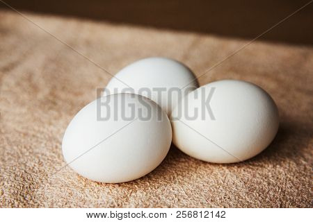 White Chicken Eggs On The Table On Brown Background