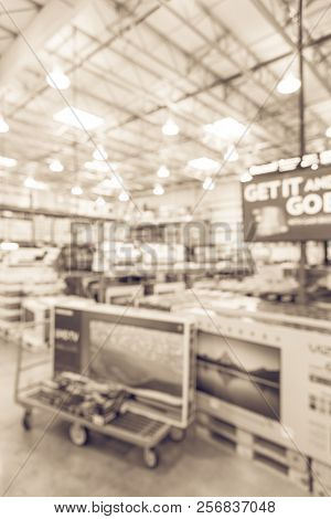 Filtered Tone Blurry Background Flatbed With Big Screen Tvs At Wholesale Store