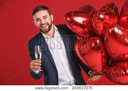 Handsome Young Man Holding Heart Shaped Baloon