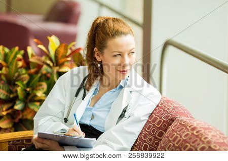 Portrait Of A Confident Woman Doctor Sitting In Her Office Relaxing Having A Midday Break From Busy 