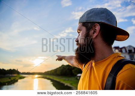 Man In Cap Enjoy Sunset While Stand On Bridge. Take Moment To Admire Sunset Nature Beauty. River Sun