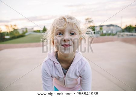Funny Gace. Portrait Of Cute Adorable Little Blonde Caucasian Girl Child Making Funny Silly Faces. K