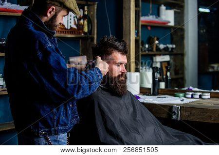 Hipster Client Getting Haircut. Barber With Hair Clipper Works On Hairstyle For Bearded Guy Barbersh