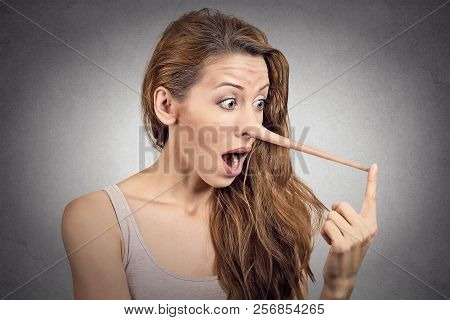 Woman With Long Nose Isolated On Grey Wall Background. Liar Concept. Human Face Expressions, Emotion
