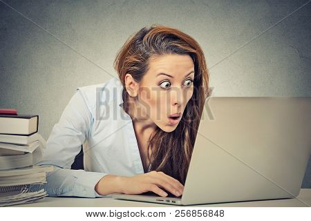 Portrait Young Shocked Business Woman Sitting In Front Of Laptop Computer Looking At Screen Isolated