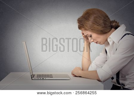 Depressed Tired Unhappy Business Woman Siting At Desk In Front Of Laptop Looking Down